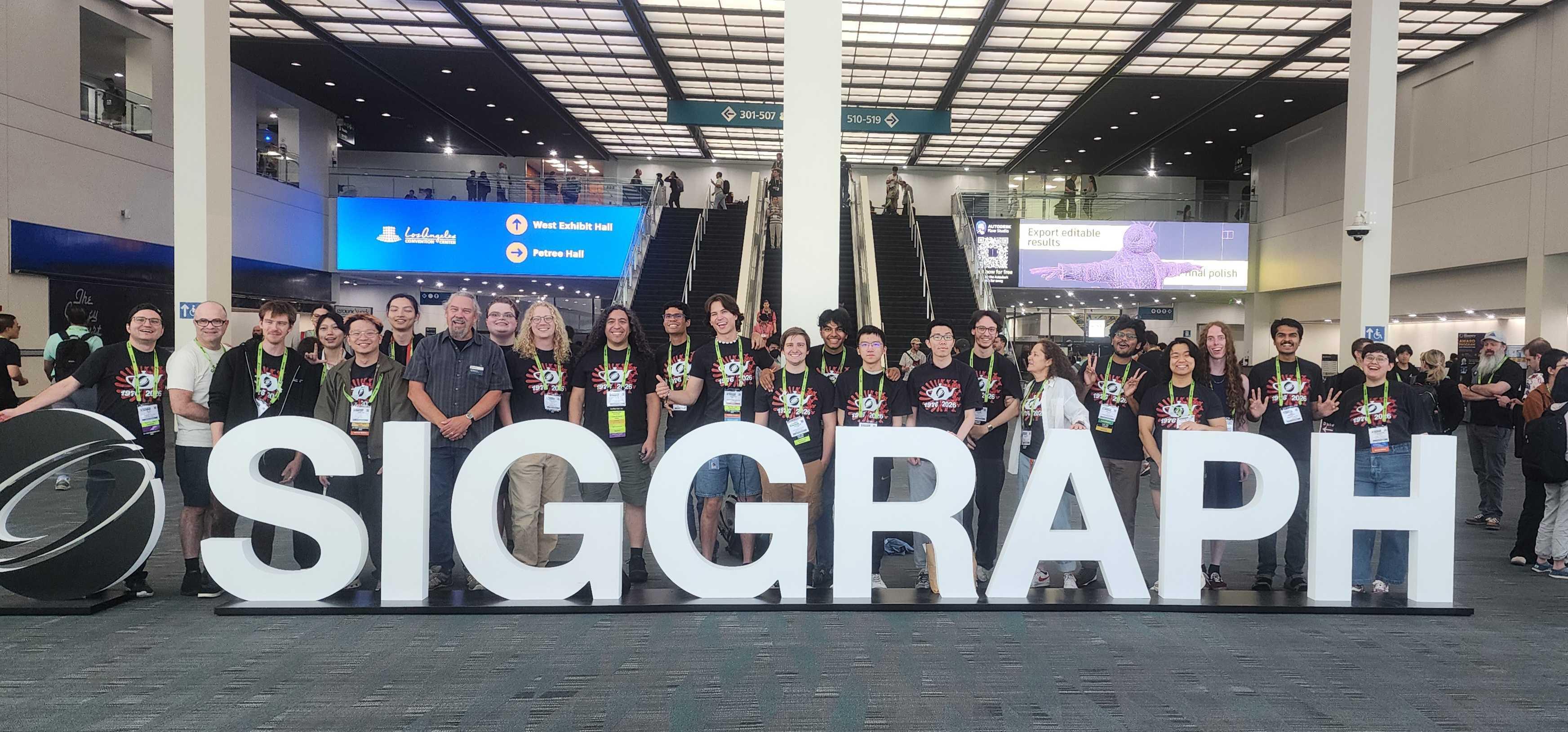 The University of Utah group of students and professors in front of the SIGGRAPH sign.
