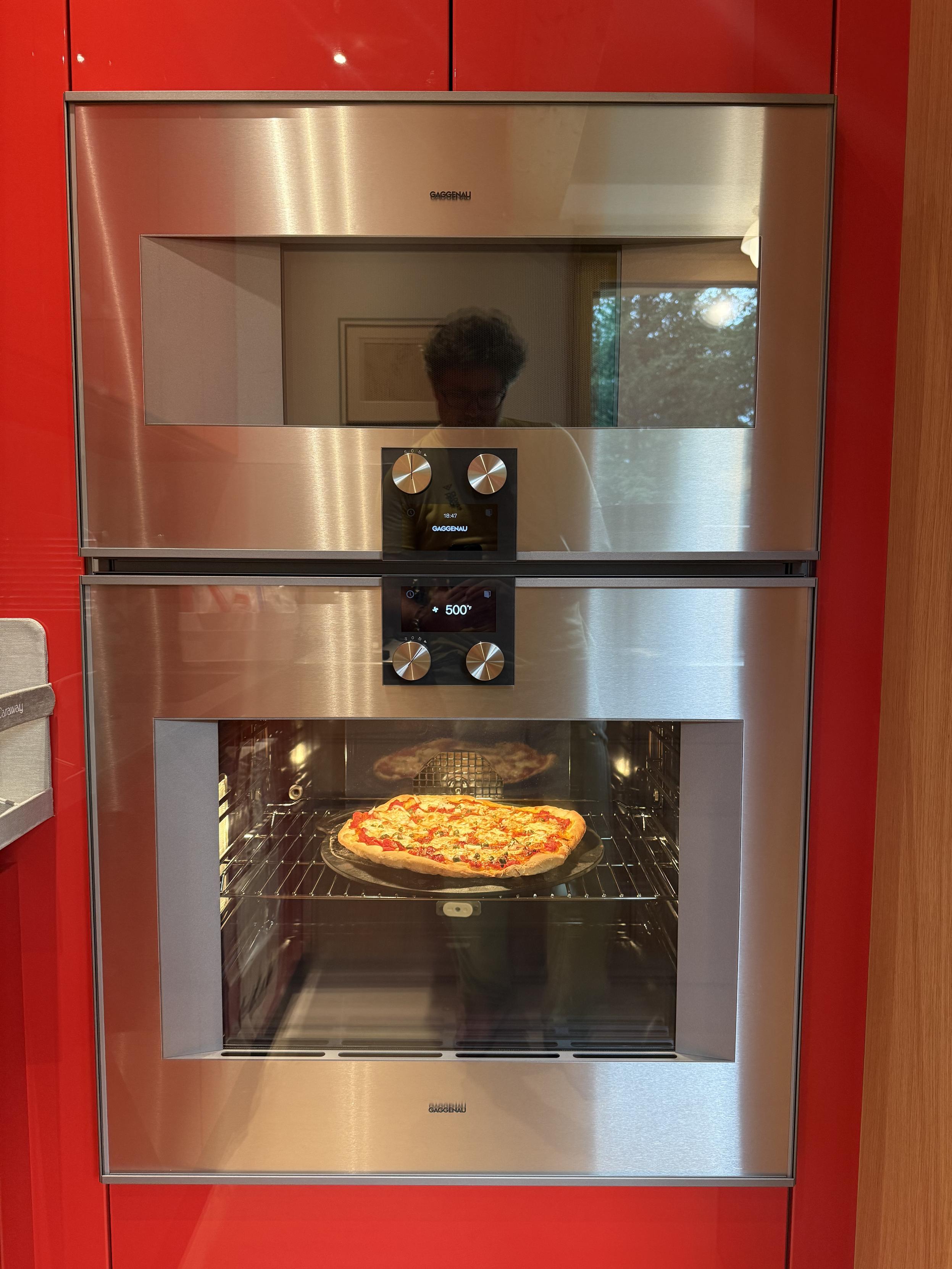 A pizza cooking in our oven